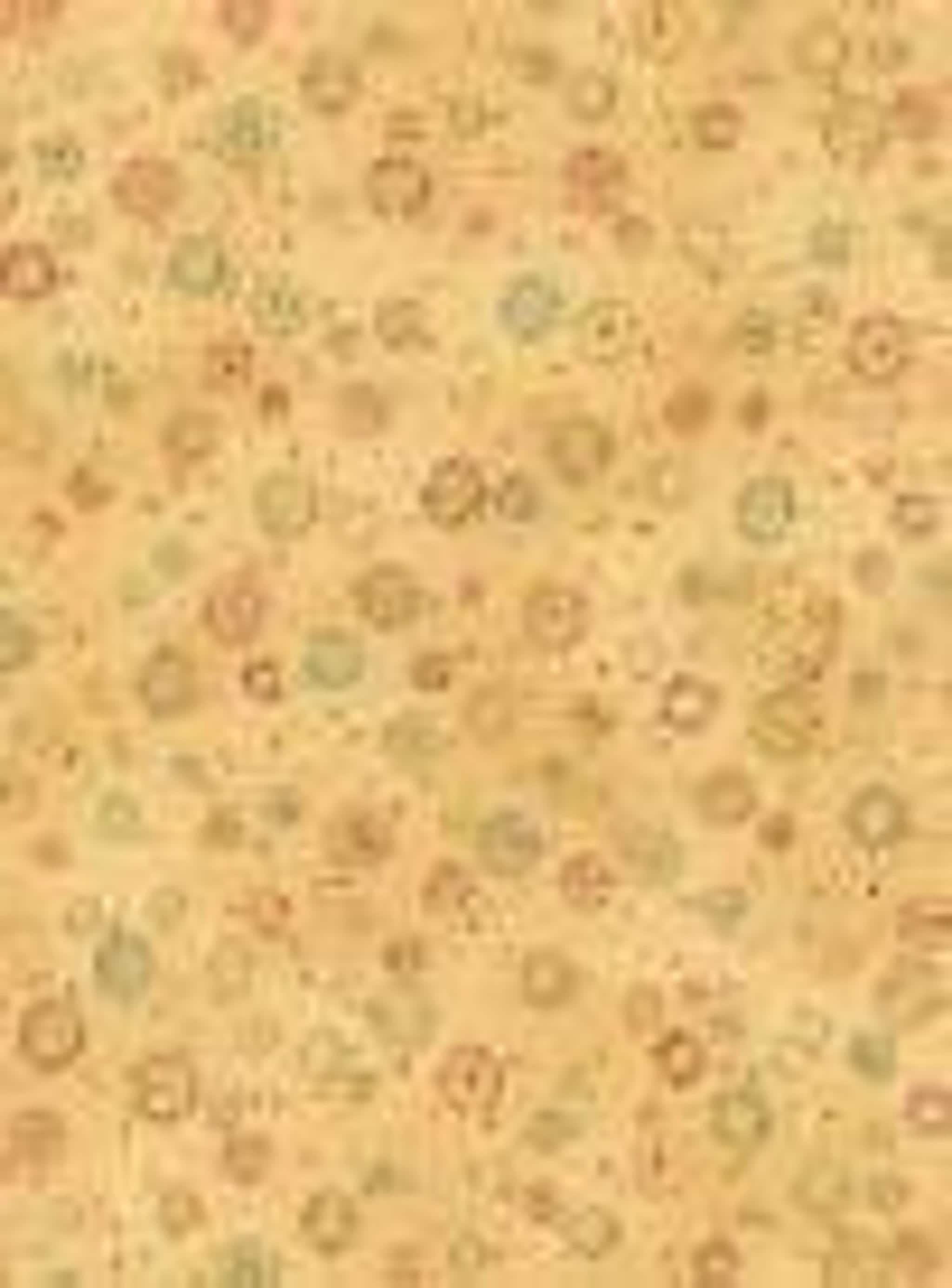 A light brown fabric with a scattered pattern of small, multi-colored circles and dots.
