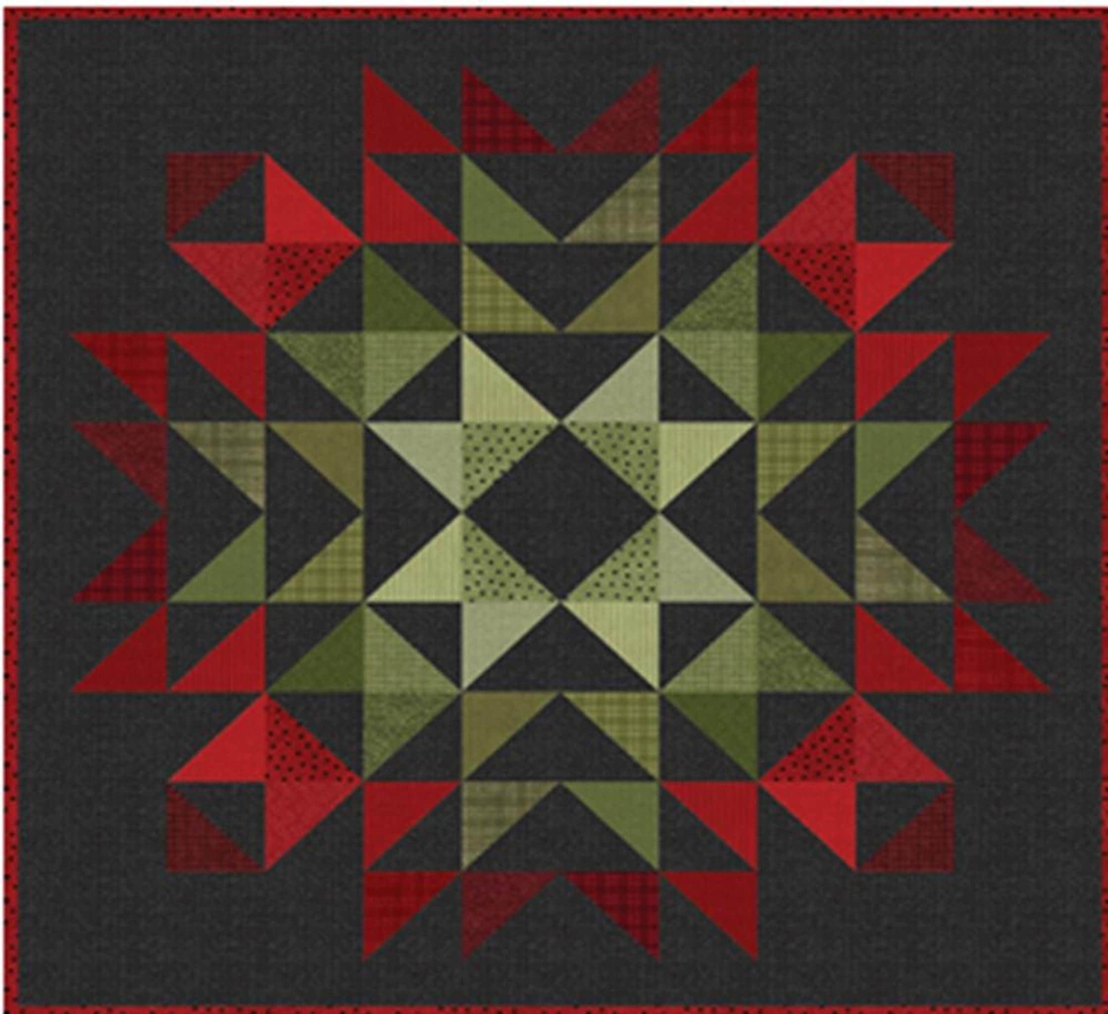 A quilt with a starburst pattern in red and green flannel, with a dark gray border.