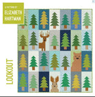 A quilt with a grid pattern of green trees, a brown deer, a brown bear, and a brown rabbit on light blue, dark blue, and tan squares, with "A PATTERN BY ELIZABETH HARTMAN" and "LOOKOUT" text.