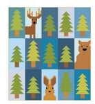 A quilt pattern showing a grid of 15 squares, with 12 squares featuring green pine trees and 3 squares featuring a brown deer, a brown bear, and a brown rabbit.
